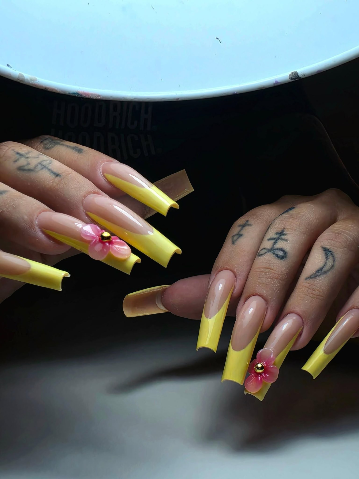 Long yellow French tips with 3D pink flowers